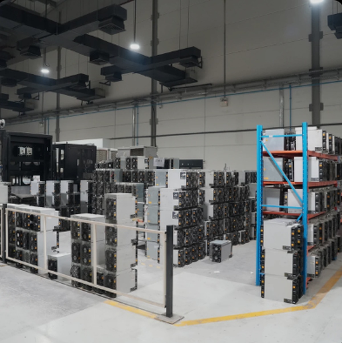Racked ASIC miners on the hosting floor